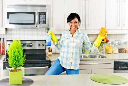 woman-cleaning-kitchen-horiz 7 simple steps to clean the kitchen